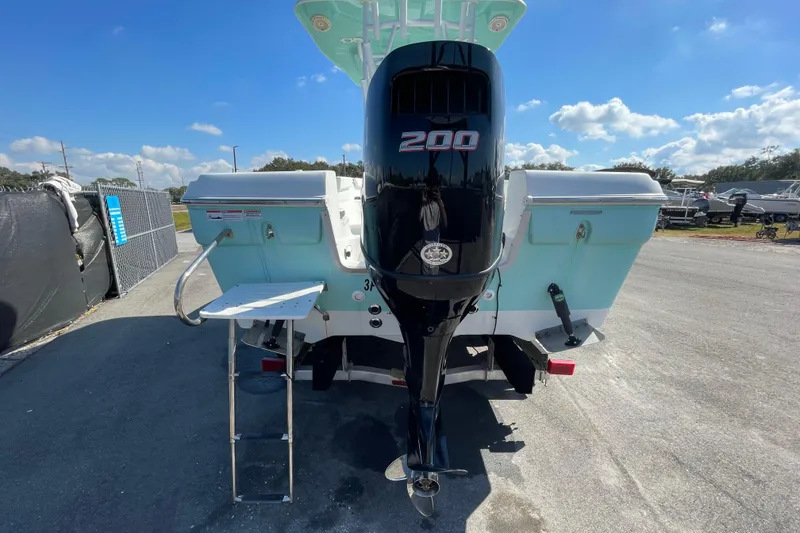 Slide: The Image of 2021 Clearwater 2200 boat with 200 HP outboard motor, docked under clear skies. - 4