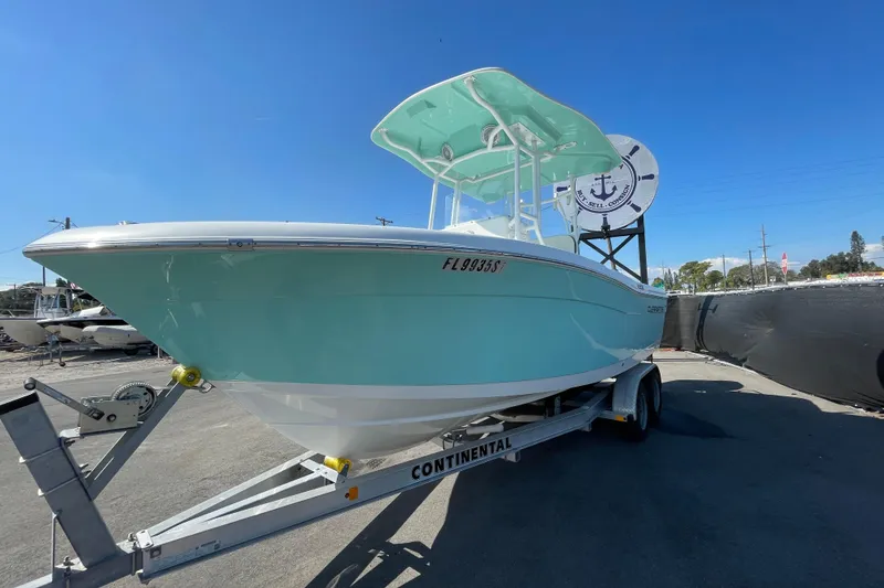 Slide: The Image of 2021 Clearwater 2200 boat on trailer under clear blue sky. - 8