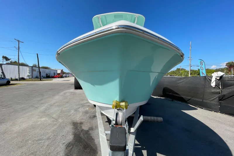 Slide: The Image of 2021 Clearwater 2200 boat on trailer under clear blue sky. - 9