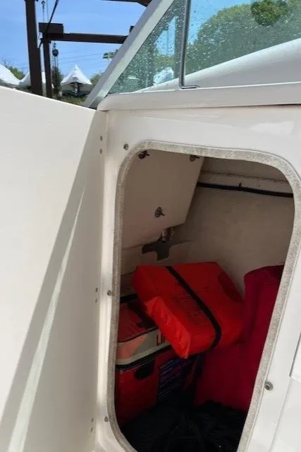 Slide: The Image of Storage compartment of 2017 Robalo R207 Dual Console with life jackets and gear. - 11