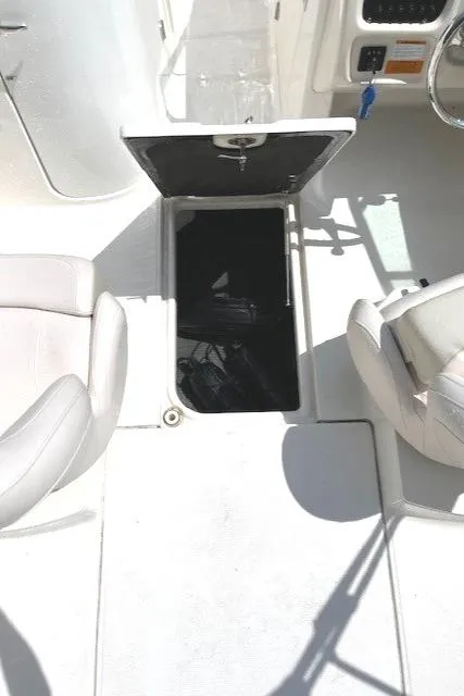 Slide: The Image of 2017 Robalo R207 Dual Console boat interior with open storage compartment. - 14