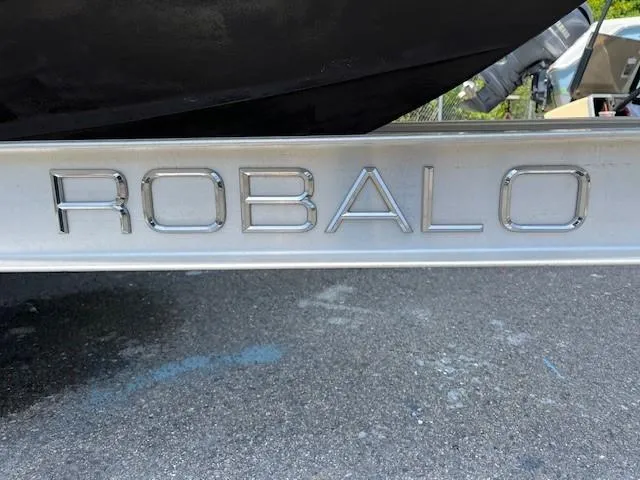 Slide: The Image of Robalo R207 Dual Console 2017 boat trailer with embossed logo on metallic surface. - 15