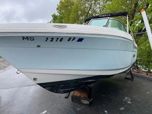 Slide: The Image of 2017 Robalo R207 Dual Console boat on a trailer, parked outdoors. - 3