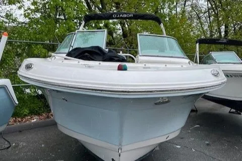 Slide: The Image of 2017 Robalo R207 Dual Console boat, white hull, parked outdoors, surrounded by trees. - 4