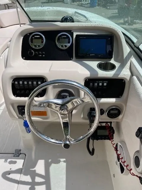Slide: The Image of 2017 Robalo R207 Dual Console boat dashboard with steering wheel and control panel. - 9