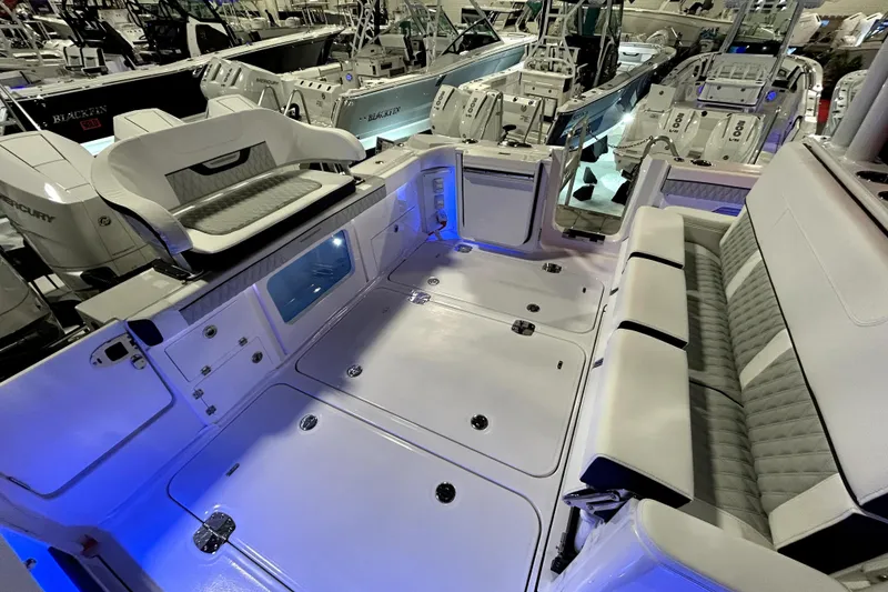 Slide: The Image of 2026 Blackfin 400 CC boat interior with luxurious seating and ambient lighting. - 11