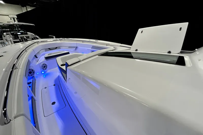 Slide: The Image of 2026 Blackfin 400 CC boat interior with blue LED lighting and sleek design. - 12