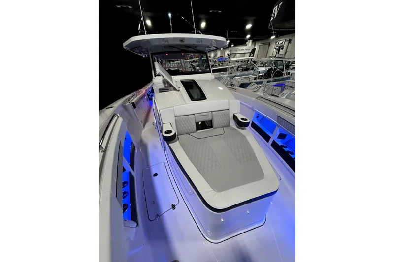 Slide: The Image of 2026 Blackfin 400 CC boat interior with blue LED lighting and modern seating. - 16