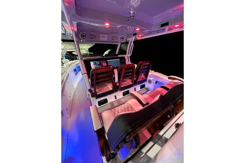Slide: The Image of 2026 Blackfin 400 CC boat interior with illuminated dashboard and luxurious seating. - 19