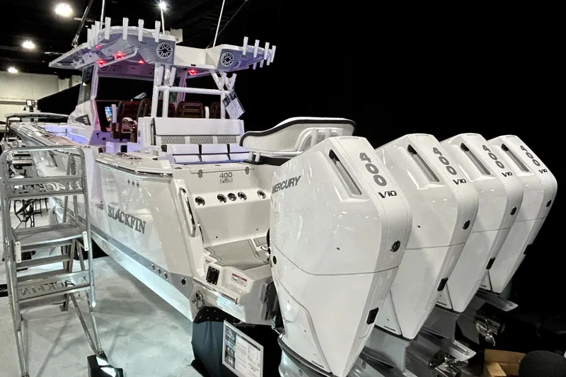 Slide: The Image of 2026 Blackfin 400 CC boat with multiple Mercury 400 V10 engines displayed indoors. - 3