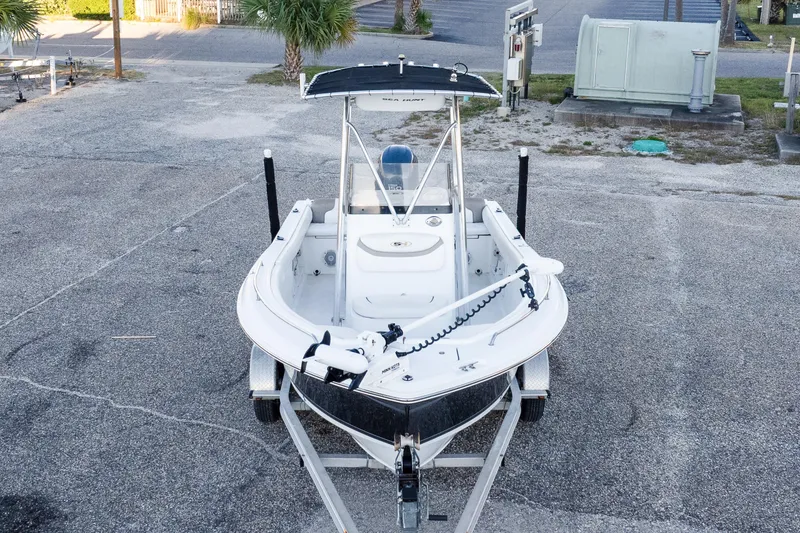 Slide: The Image of 2010 Sea Hunt Ultra 210 boat on trailer, parked in a lot. - 10