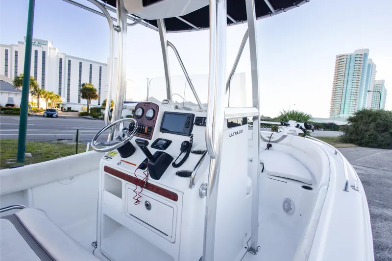 Slide: The Image of 2010 Sea Hunt Ultra 210 boat interior with steering console and modern navigation equipment. - 15