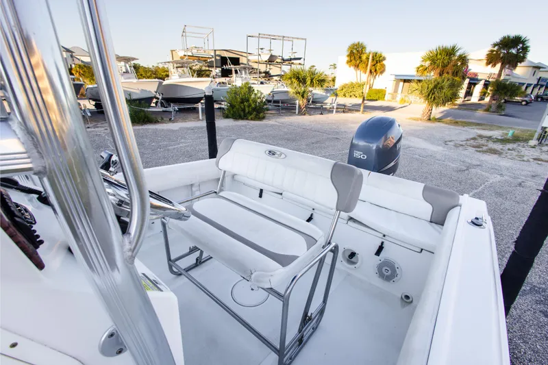 Slide: The Image of 2010 Sea Hunt Ultra 210 boat with Yamaha 150 engine, parked in a marina. - 21