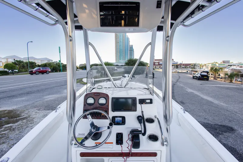Slide: The Image of 2010 Sea Hunt Ultra 210 boat dashboard with steering wheel and navigation equipment. - 22