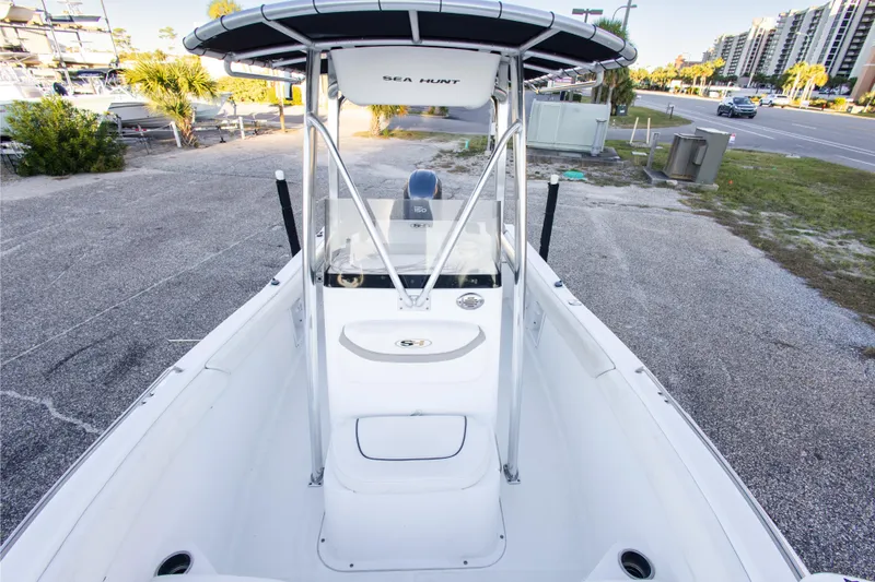 Slide: The Image of 2010 Sea Hunt Ultra 210 boat battery compartment with wiring and equipment. - 28