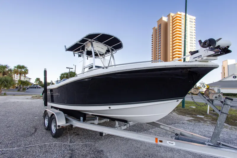 Slide: The Image of 2010 Sea Hunt Ultra 210 boat on trailer, urban background with tall buildings. - 4