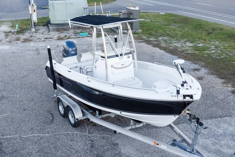 Slide: The Image of 2010 Sea Hunt Ultra 210 boat on trailer, parked in a lot. - 5