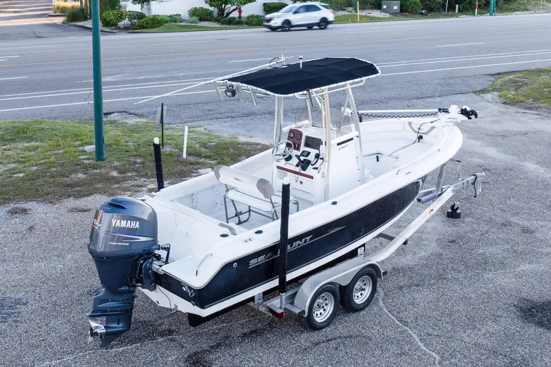 Slide: The Image of 2010 Sea Hunt Ultra 210 boat on trailer with Yamaha outboard motor. - 7