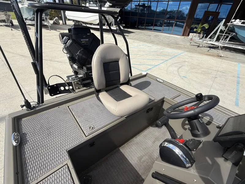 Slide: The Image of 2022 Gator Tail Extreme Series 1860CC boat interior with steering wheel and seat. - 11