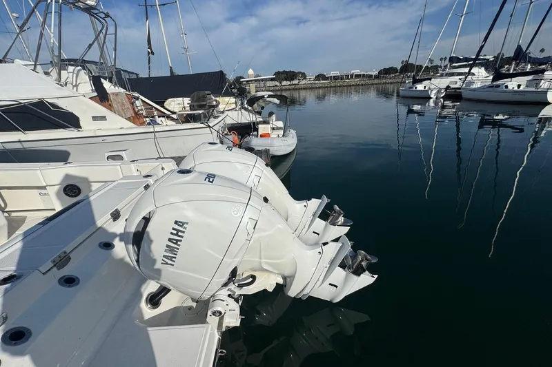 Slide: The Image of 2025 Robalo R270 Center Console with Yamaha engines docked in marina. - 12