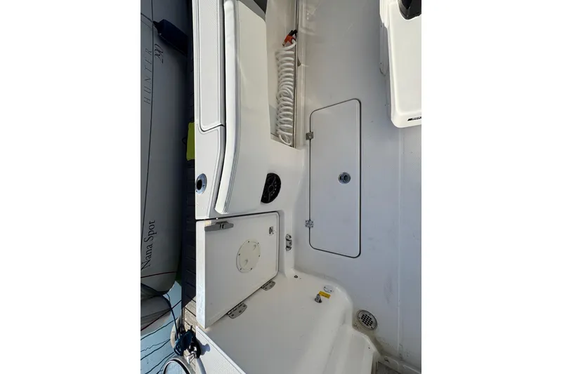 Slide: The Image of 2025 Robalo R270 Center Console boat interior with storage compartments and seating. - 15