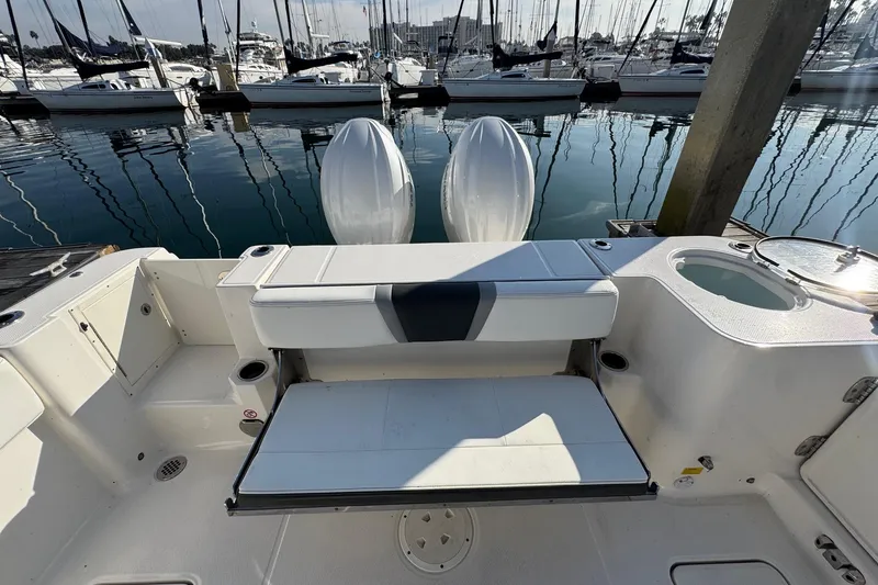 Slide: The Image of 2025 Robalo R270 Center Console boat with dual engines docked at marina. - 16