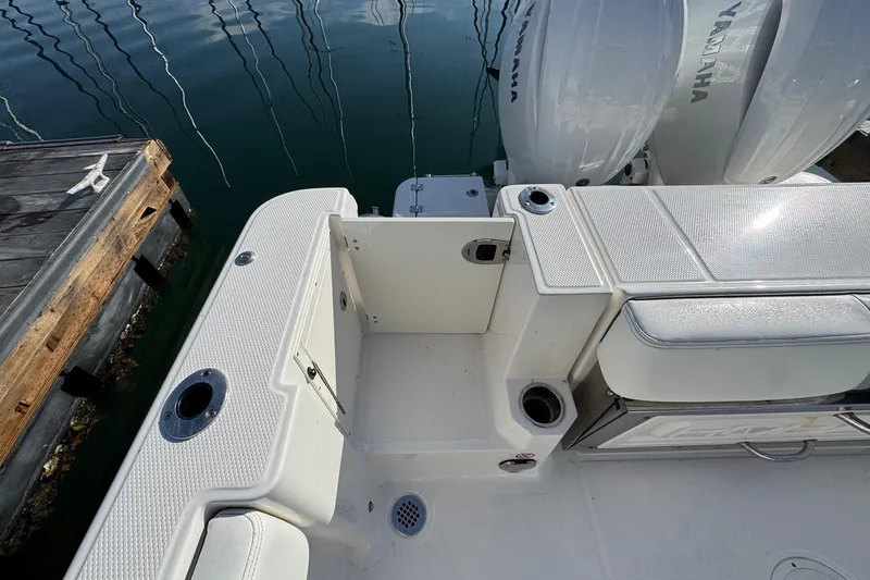 Slide: The Image of 2025 Robalo R270 Center Console boat with Yamaha engines at dock. - 18