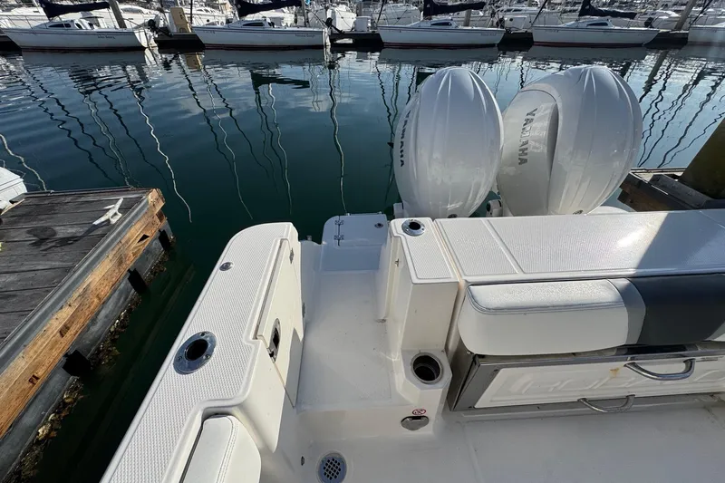 Slide: The Image of 2025 Robalo R270 Center Console boat with Yamaha engines docked at marina. - 19