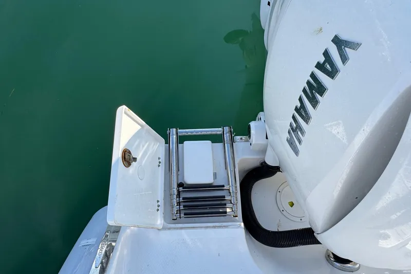 Slide: The Image of 2025 Robalo R270 Center Console with Yamaha engine, featuring a swim ladder and open hatch. - 21