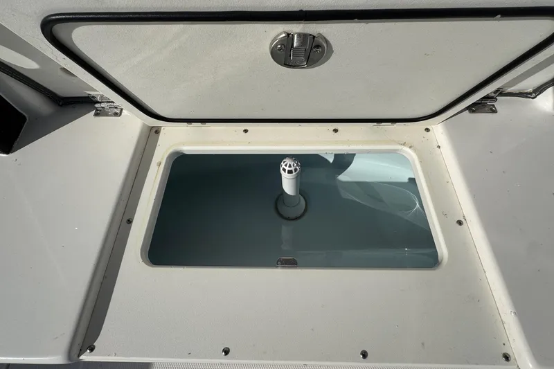 Slide: The Image of Open storage compartment on 2025 Robalo R270 Center Console boat. - 24
