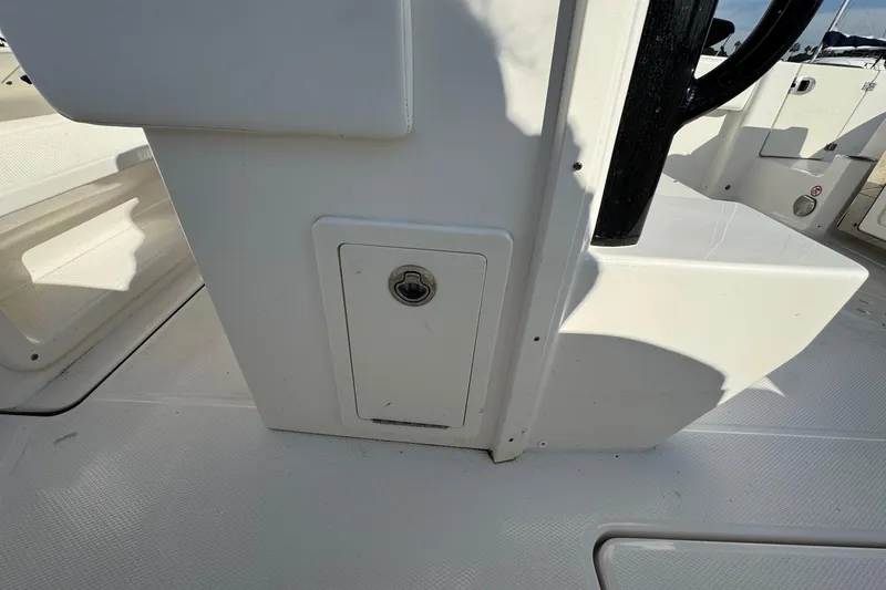 Slide: The Image of 2025 Robalo R270 Center Console interior detail, featuring a storage compartment. - 27