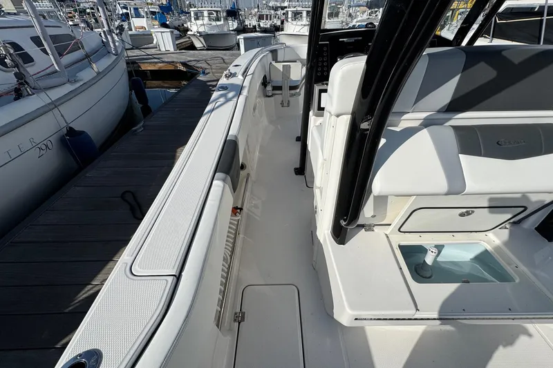 Slide: The Image of 2025 Robalo R270 Center Console boat docked, showcasing sleek design and spacious deck. - 28