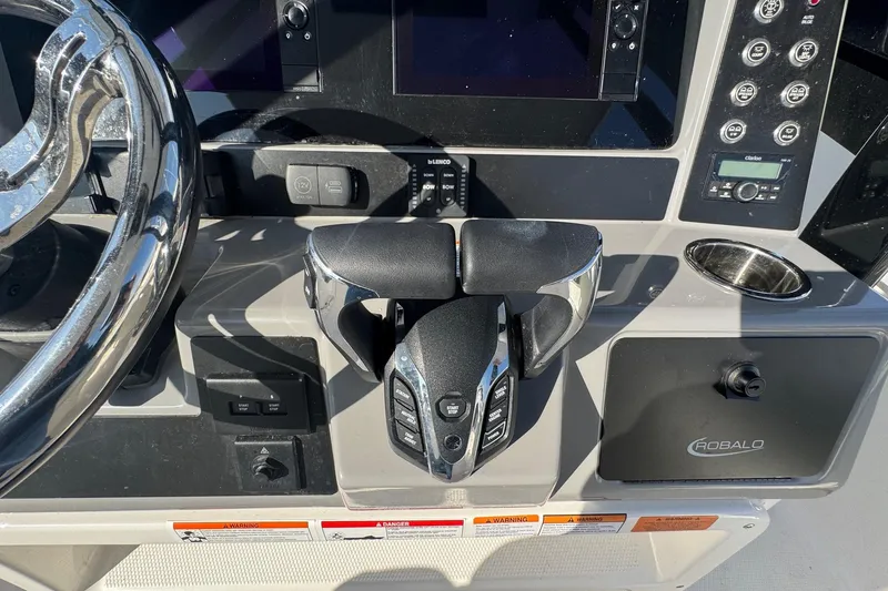 Slide: The Image of 2025 Robalo R270 Center Console boat dashboard with steering wheel and controls. - 36