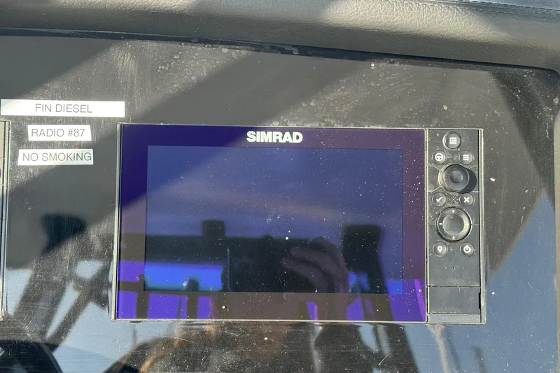 Slide: The Image of Simrad display on 2025 Robalo R270 Center Console boat dashboard with labels. - 38