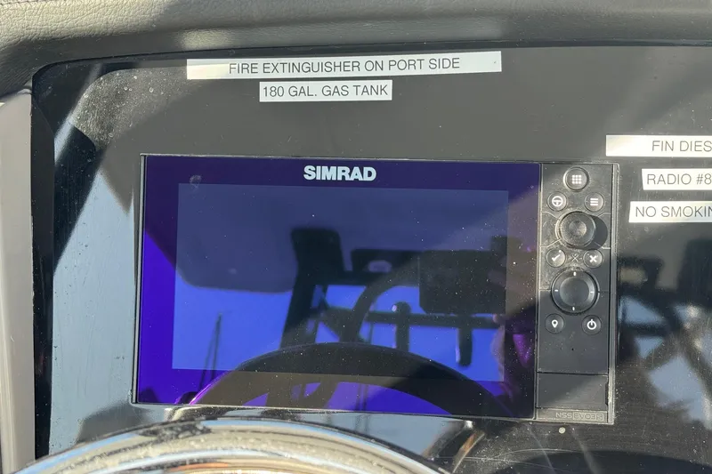 Slide: The Image of Simrad display on 2025 Robalo R270 Center Console boat dashboard with safety labels. - 39