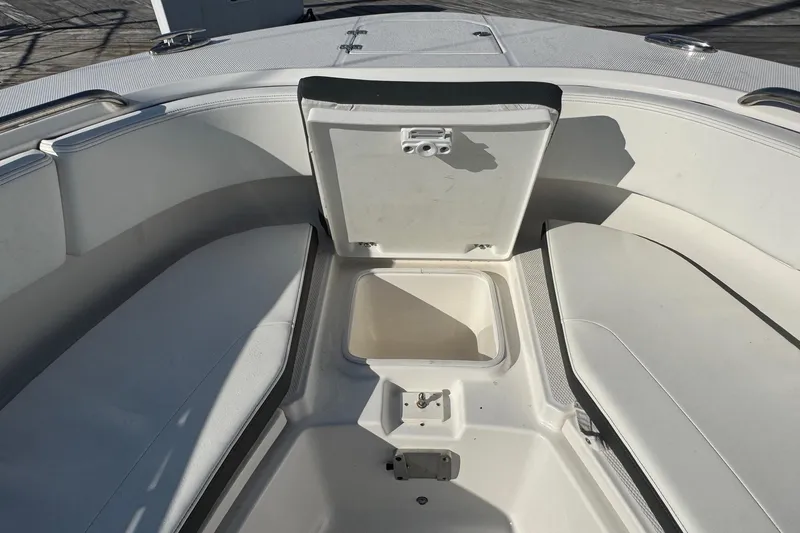 Slide: The Image of 2025 Robalo R270 Center Console boat interior with open storage compartment. - 49