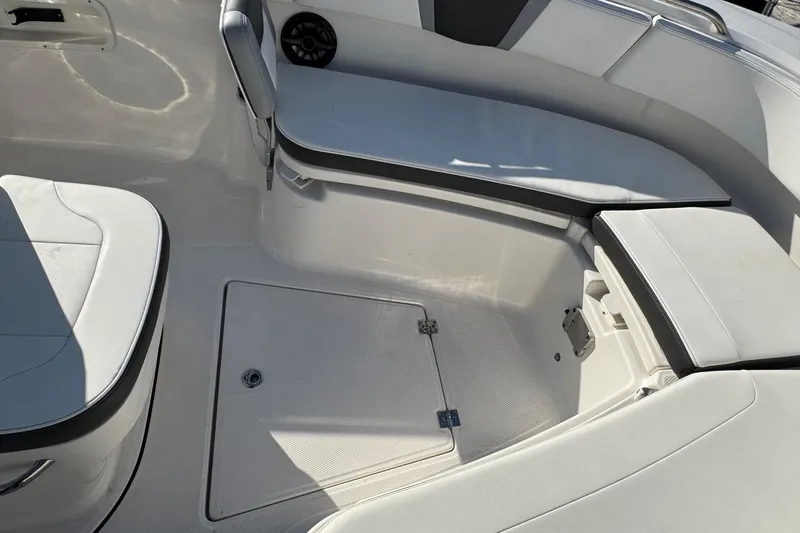 Slide: The Image of 2025 Robalo R270 Center Console boat interior with cushioned seating and storage. - 51