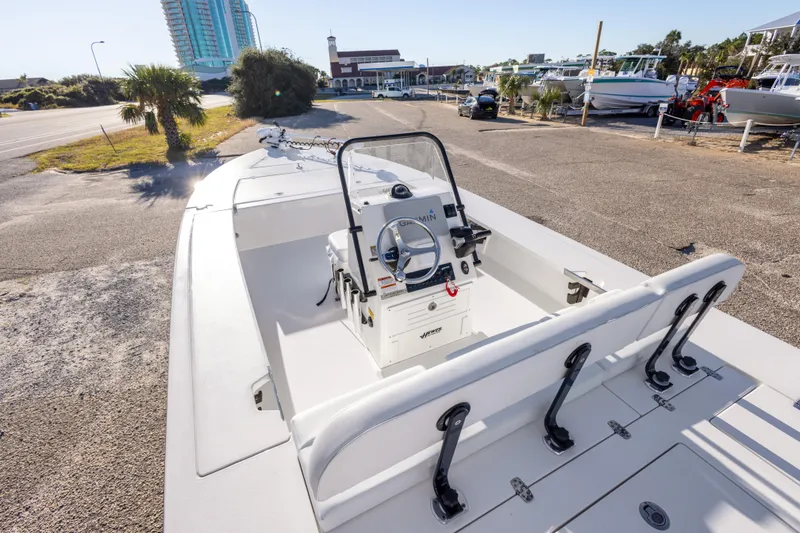 Slide: The Image of 2023 Hewes Redfisher 21 boat interior with steering console, parked near marina. - 16