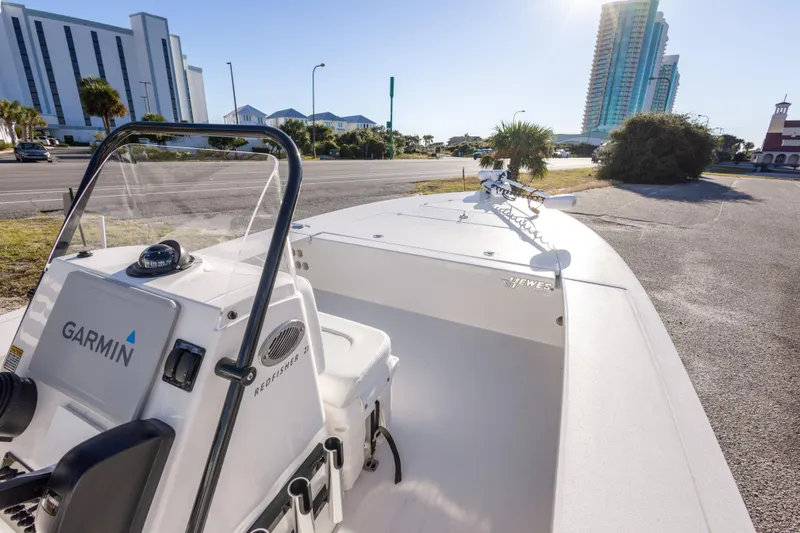 Slide: The Image of 2023 Hewes Redfisher 21 boat with Garmin equipment, parked near modern buildings. - 17