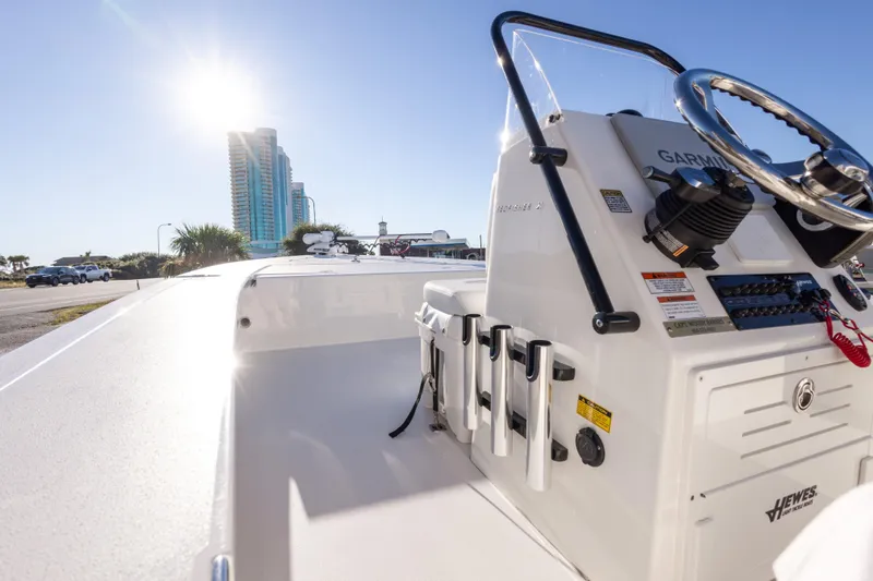 Slide: The Image of 2023 Hewes Redfisher 21 boat with Garmin equipment, sunny day, urban backdrop. - 19