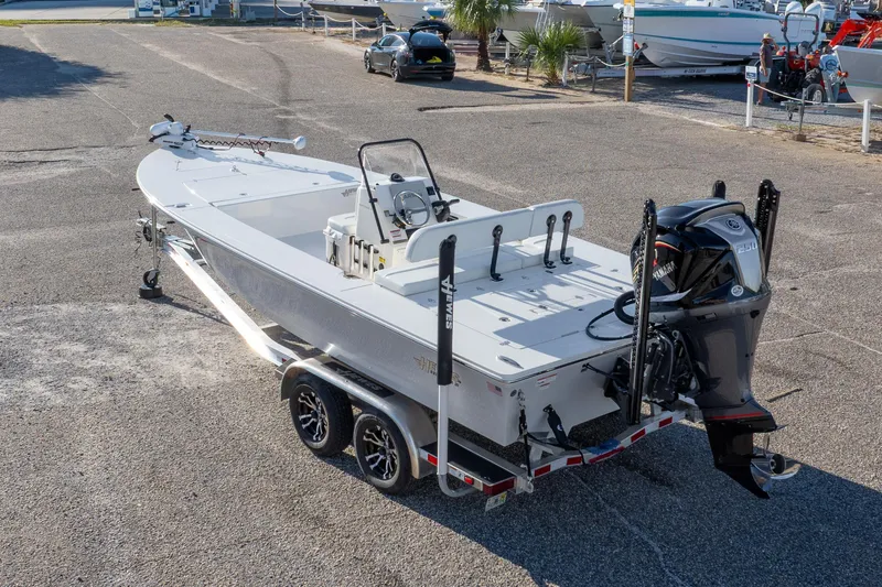 Slide: The Image of 2023 Hewes Redfisher 21 boat on trailer, featuring Yamaha outboard motor. - 2