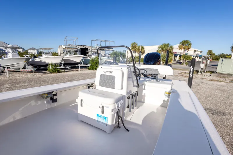 Slide: The Image of 2023 Hewes Redfisher 21 boat, white interior, parked outdoors under clear blue sky. - 21