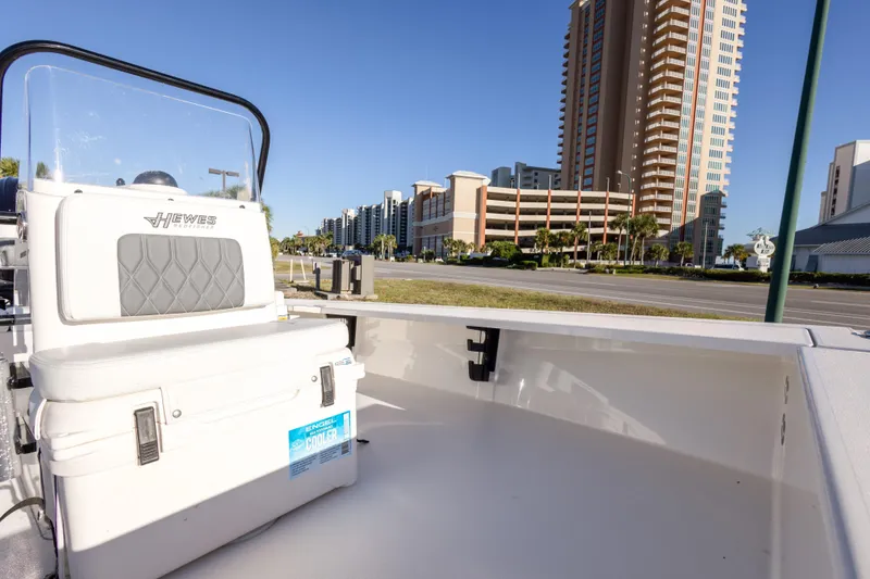 Slide: The Image of 2023 Hewes Redfisher 21 boat with cooler, cityscape background, sunny day. - 23