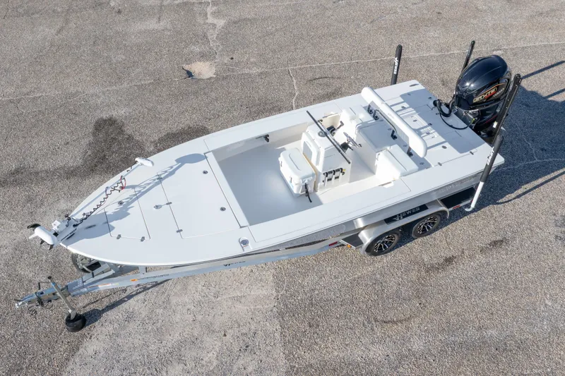 Slide: The Image of 2023 Hewes Redfisher 21 boat on trailer, aerial view, parked on concrete surface. - 3