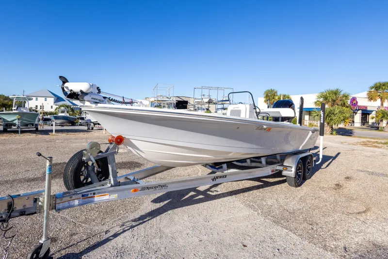 Slide: The Image of 2023 Hewes Redfisher 21 boat on trailer in sunny outdoor setting. - 7