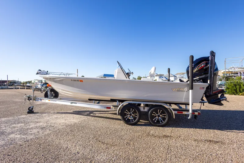 Slide: The Image of 2023 Hewes Redfisher 21 boat on trailer, parked outdoors under clear blue sky. - 9