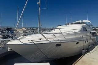The Image of 1996 Princess yacht docked at marina under clear blue sky. - 0