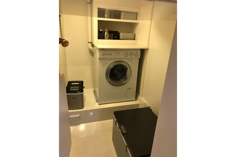 Slide: The Image of Compact laundry area with a washing machine, storage shelves, and a small appliance. - 10