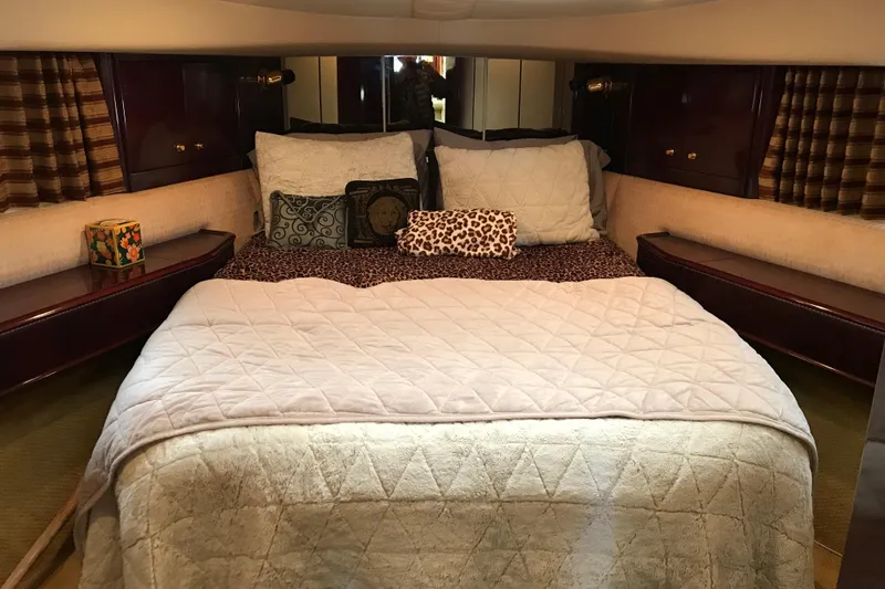 Slide: The Image of Luxurious bedroom interior of a 1996 Princess model yacht with plush bedding and elegant decor. - 11