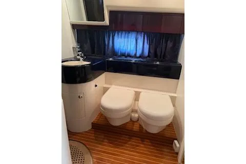 Slide: The Image of Bathroom interior of a 1996 Princess model yacht with dual toilets and wooden flooring. - 14